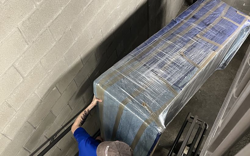 A blanket-wrapped stack of furniture ready to load