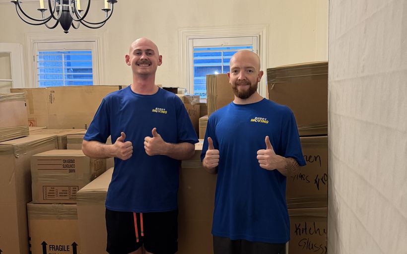 A buddy carrying office boxes out through the hall